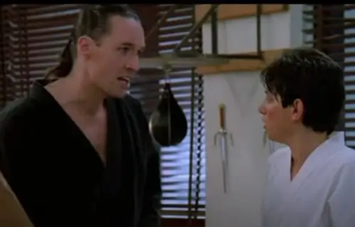 An image of Terry Silver stood next to Daniel LaRusso as he introduces the quicksilver method